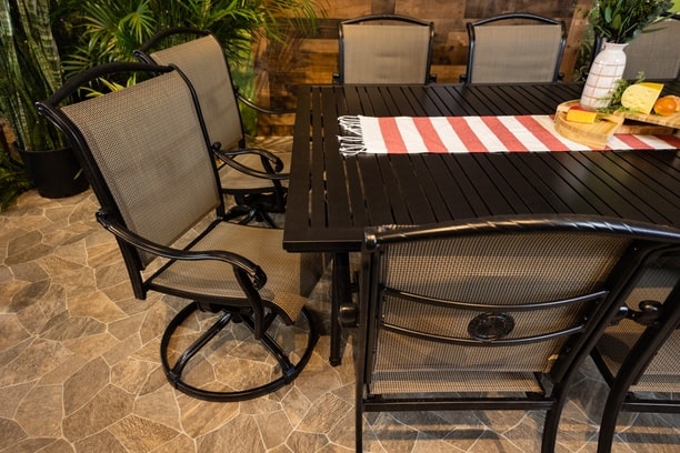 DWL Glenhaven Vienna Sling Aluminum Outdoor Dining 60x93 Stone Harbor Table with 6 Stationary and 4 Swivel Dining Chairs